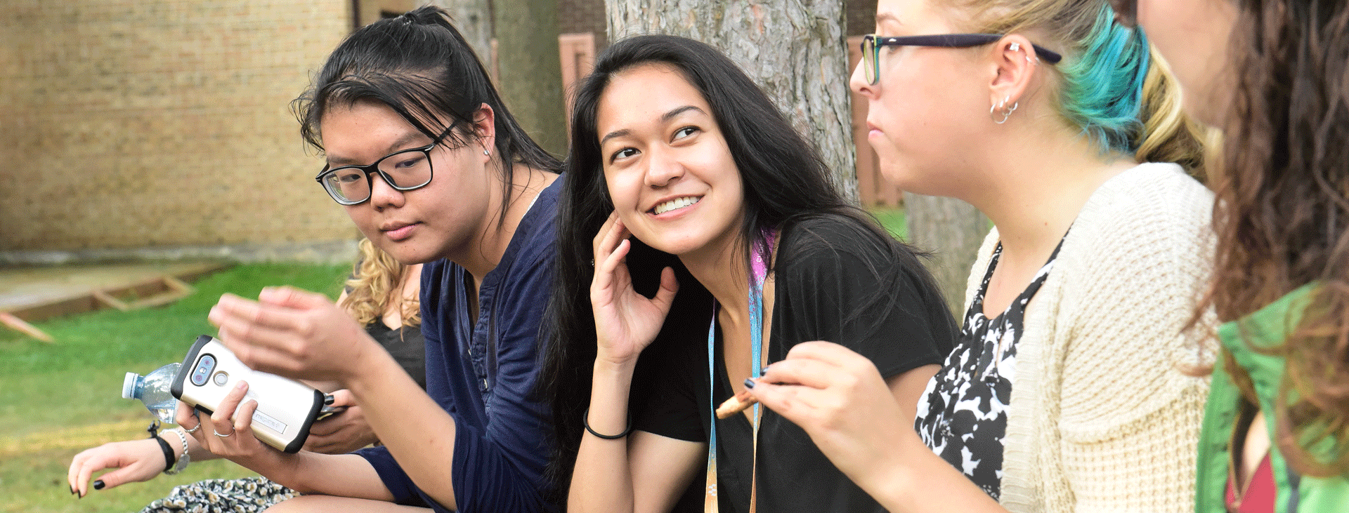 Four young women from diverse backgrounds chatting together