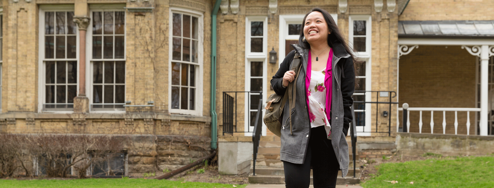Female student walking confidently outside of Cumberland House