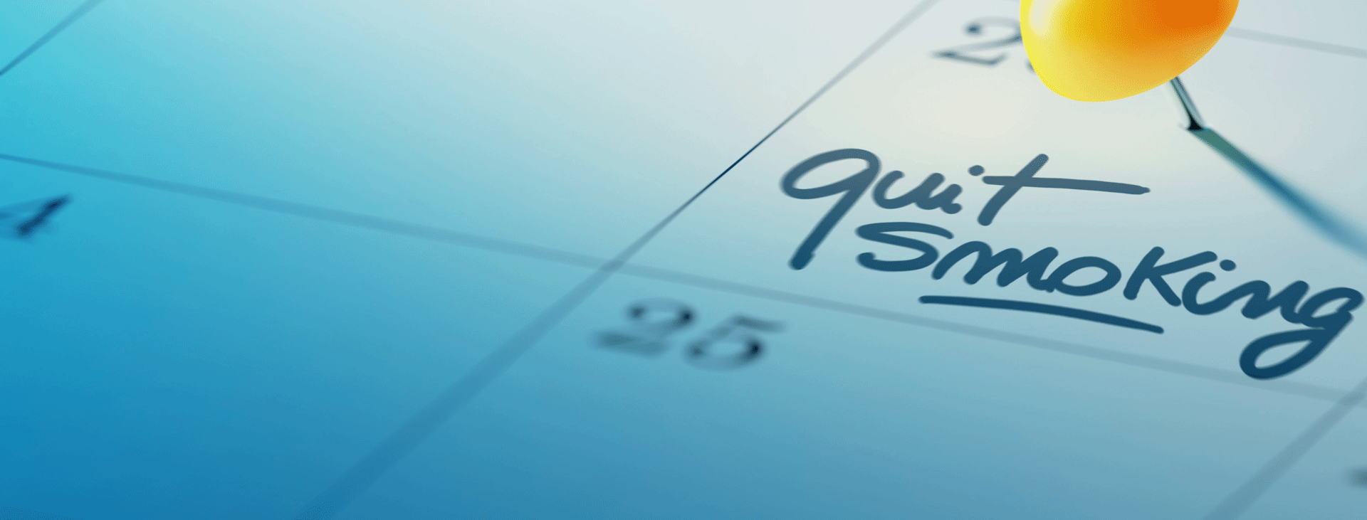 Quit smoking written on a calendar with yellow stick pin