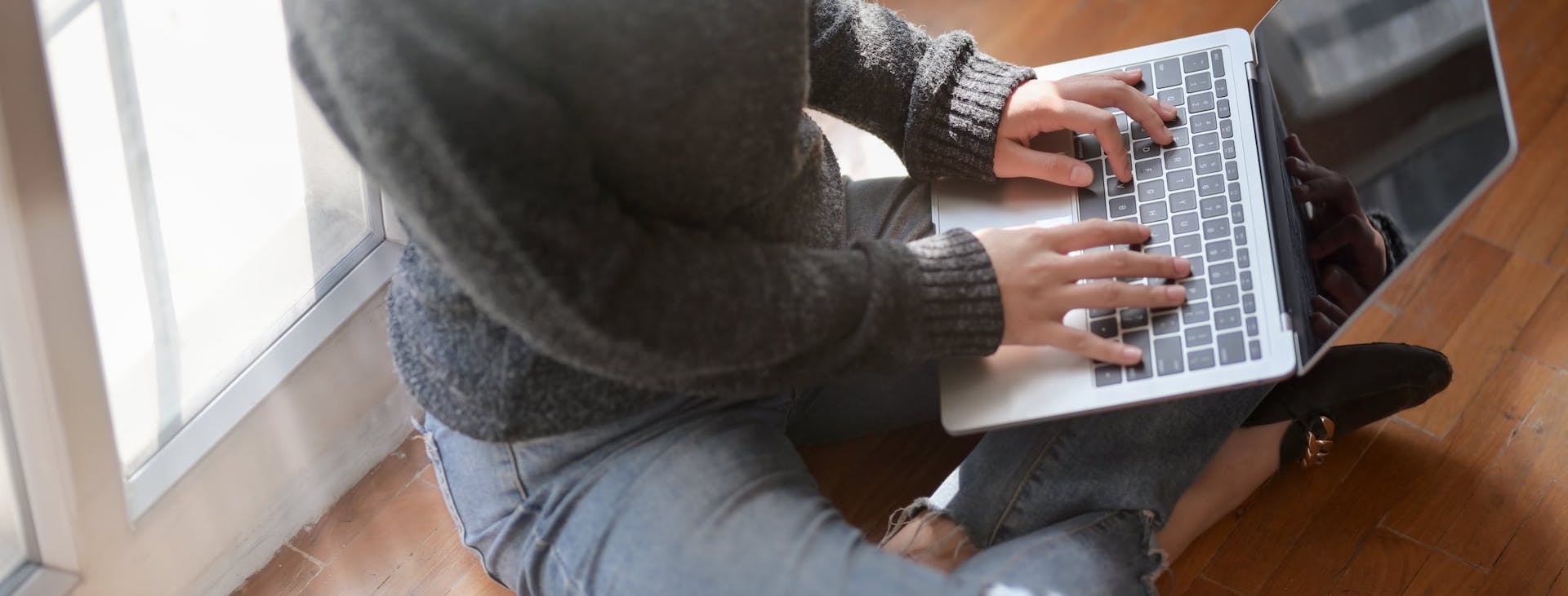 Woman sitting on floor with laptop