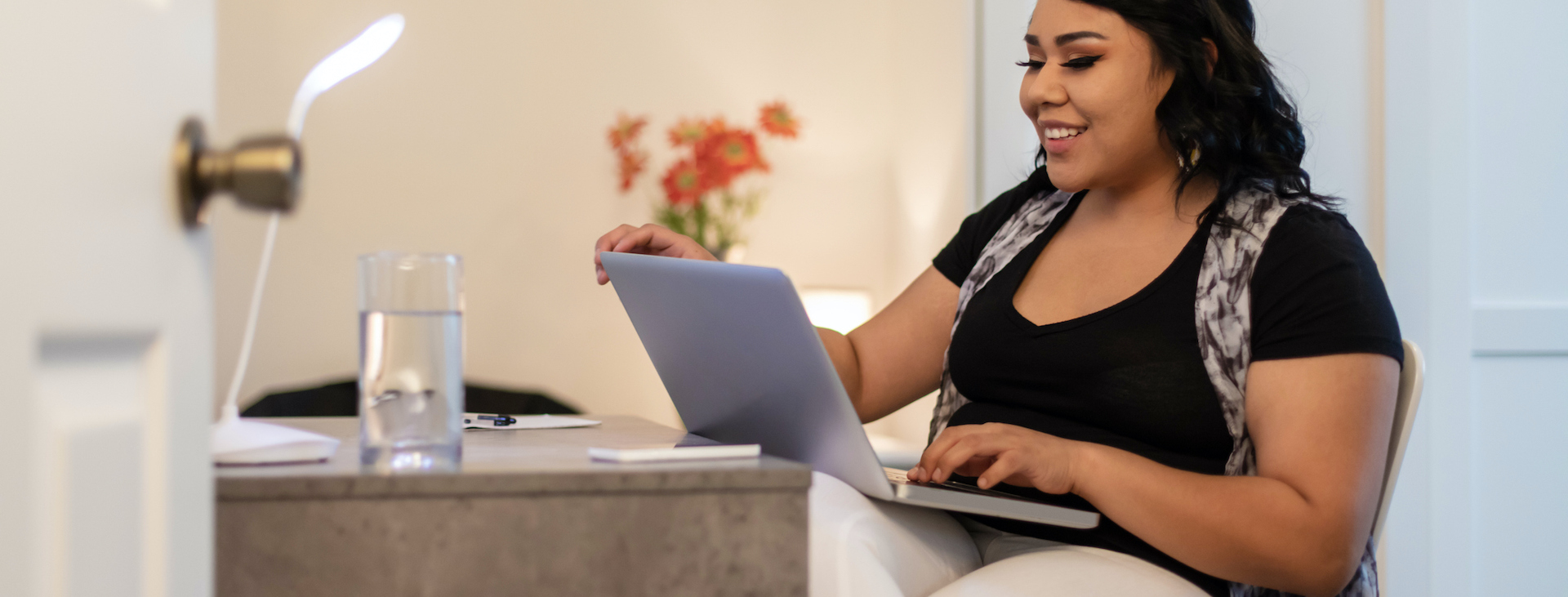 Indigenous student works on laptop at home